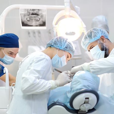Team performing dental implant surgery