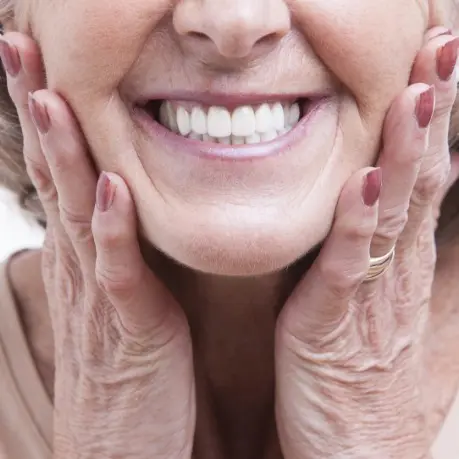 A close up of an older woman smiling