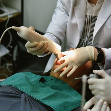 A person is getting his teeth examined by an ent doctor.