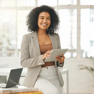 A woman in brown jacket holding a tablet.