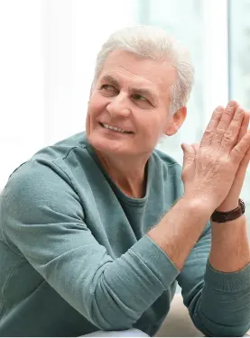 A man clapping his hands while sitting down.