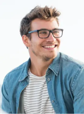 A man with glasses smiling for the camera.