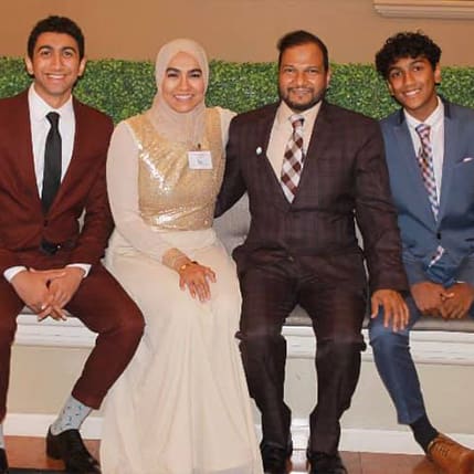 A group of people in suits and ties posing for the camera.