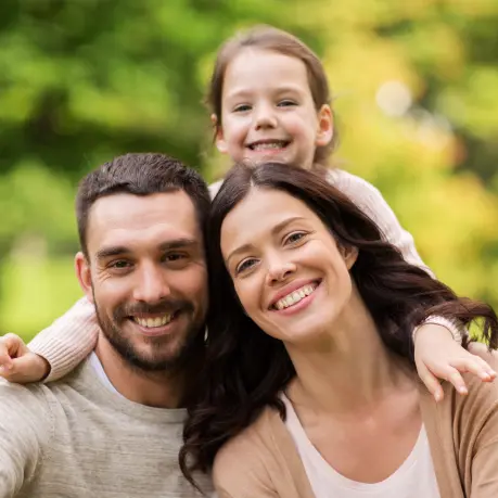 A family of three posing for the camera.