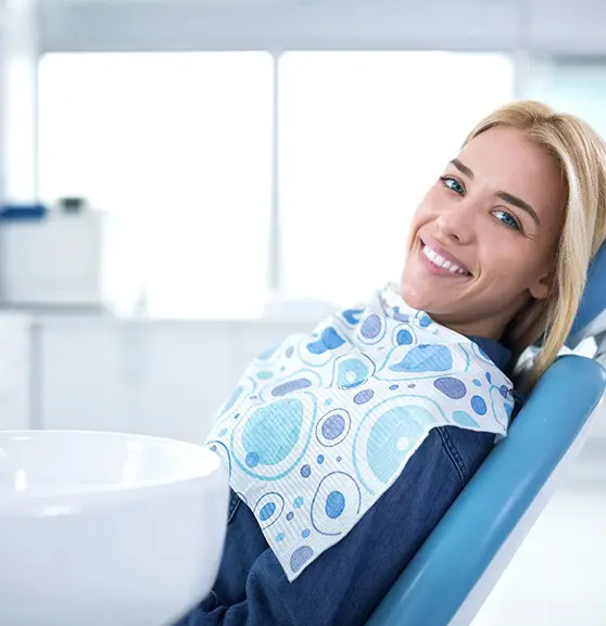 A woman sitting in the dentist chair smiling.