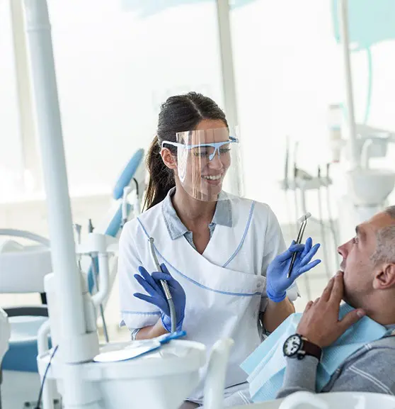 A dentist and his patient in the dental chair.