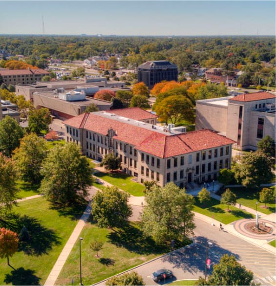 An aerial view of a campus with buildings and trees.